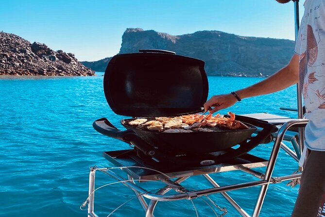Half-Day Exclusive Catamaran Cruise in Santorini with Meal and Open Bar - The Sailing Views Between Stops: Fira’s Old Port and the Volcanic Rocks