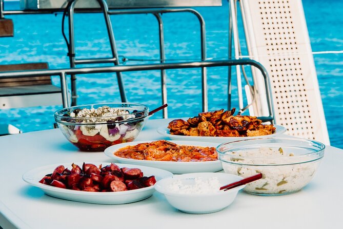 Santorini Caldera Gold Day Cruise with BBQ on board and Open Bar - Black Mountain and Indian Rock: A Scenic Sail-Past Without the Stress