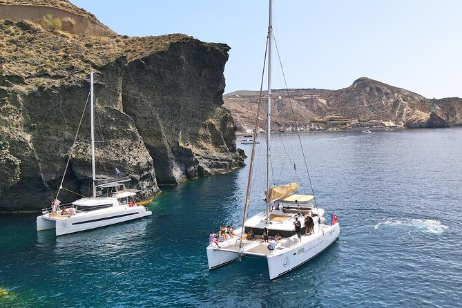 Santorini Catamaran Cruise: with Lunch, BBQ, Open Bar, Transfers - Sailing Highlights to White Beach, Indian Rocks, and the Venetian Lighthouse