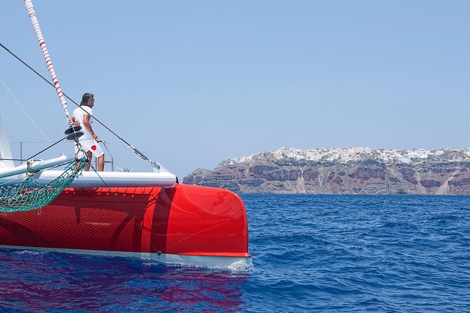 Santorini Cruise on Catamaran with BBQ & Open Bar - Stop 3: White Beach, Limestone Walls, and BBQ Lunch